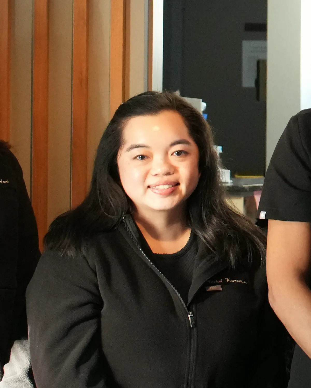Rachel, the office’s insurance coordinator, smiling at the reception desk