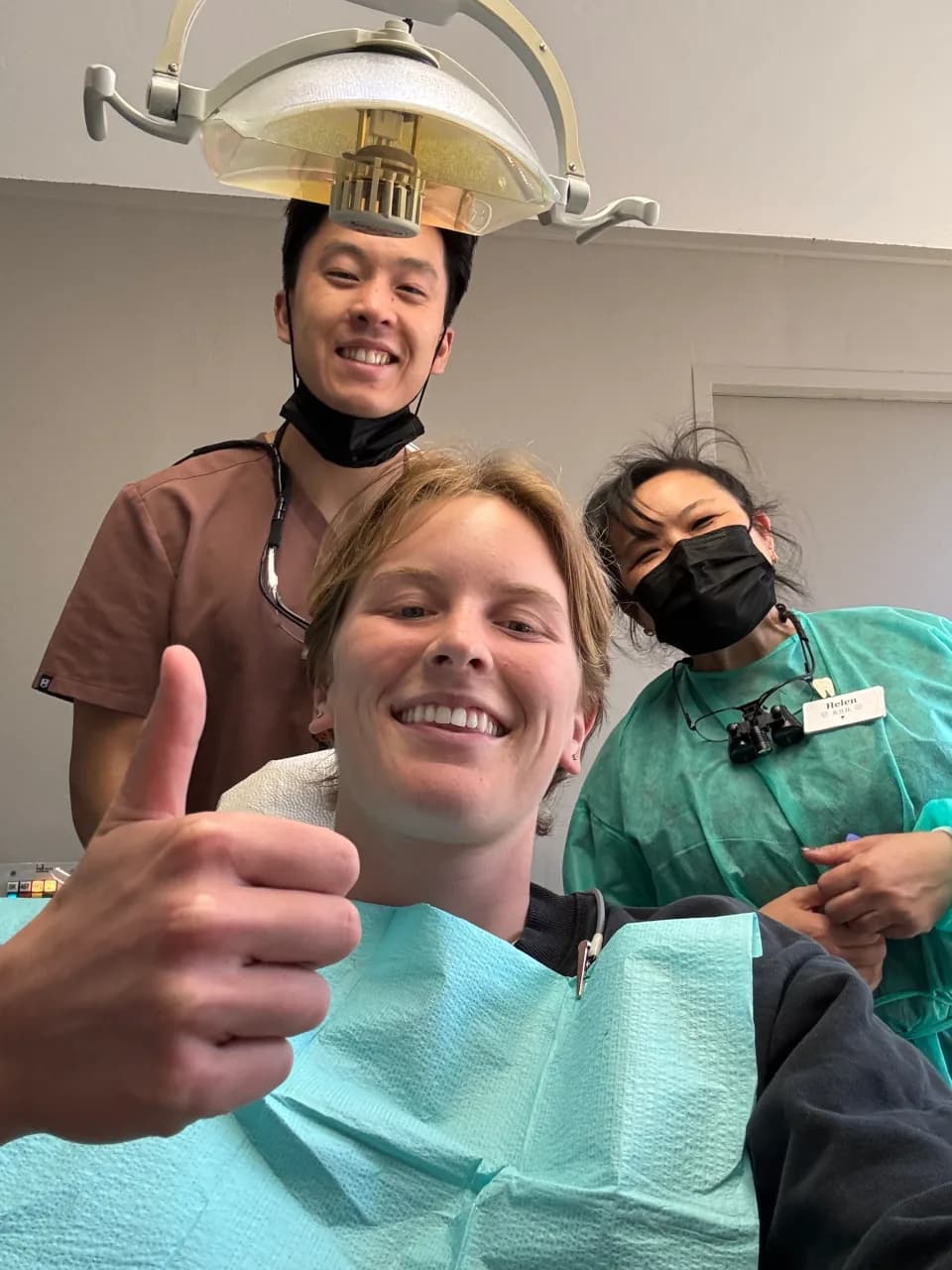 Lauren Hall smiling with the dental team after an appointment